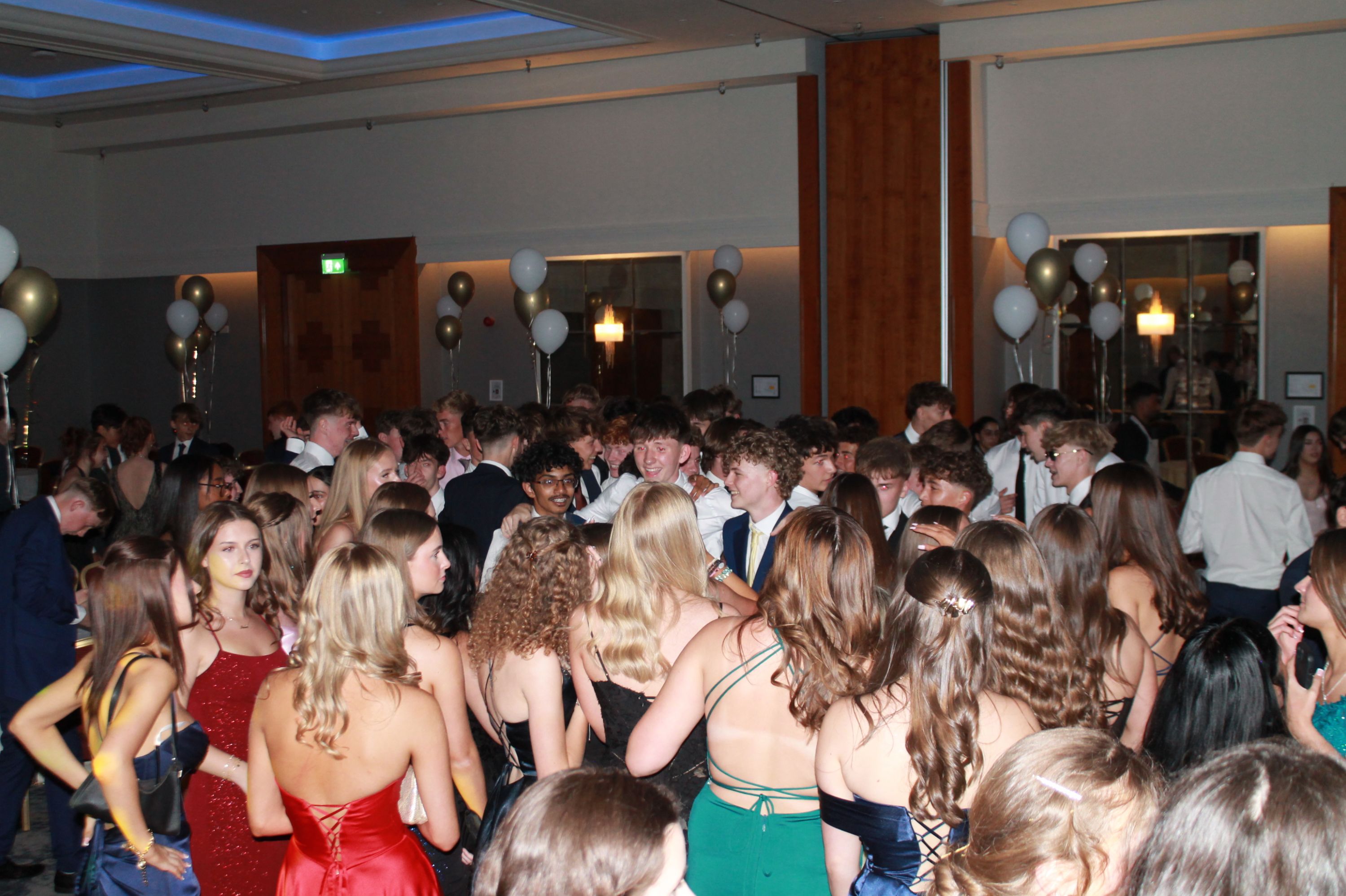 a group of students enjoying prom dancing