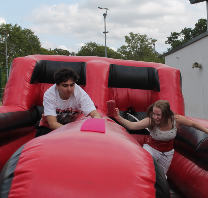 two students enjoying the inflatables