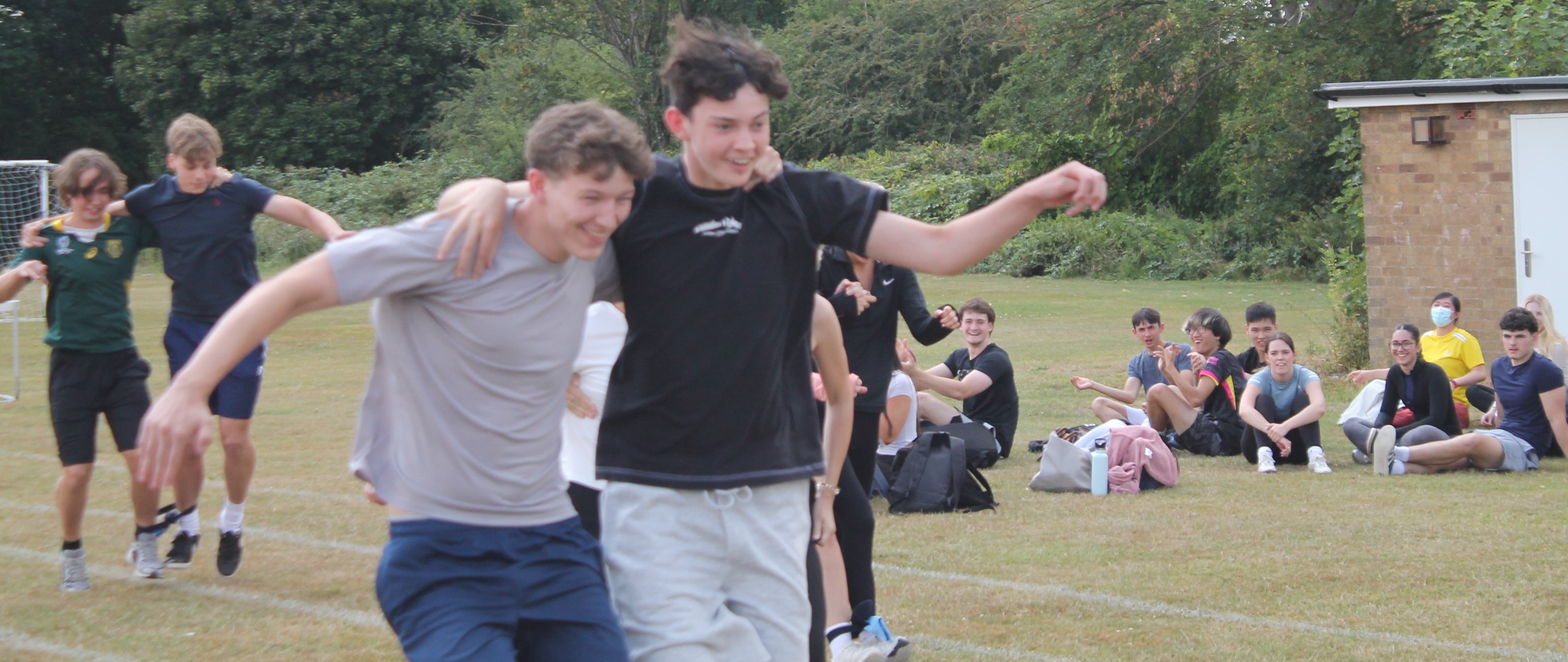 four students in pairs in  a three legged ace  