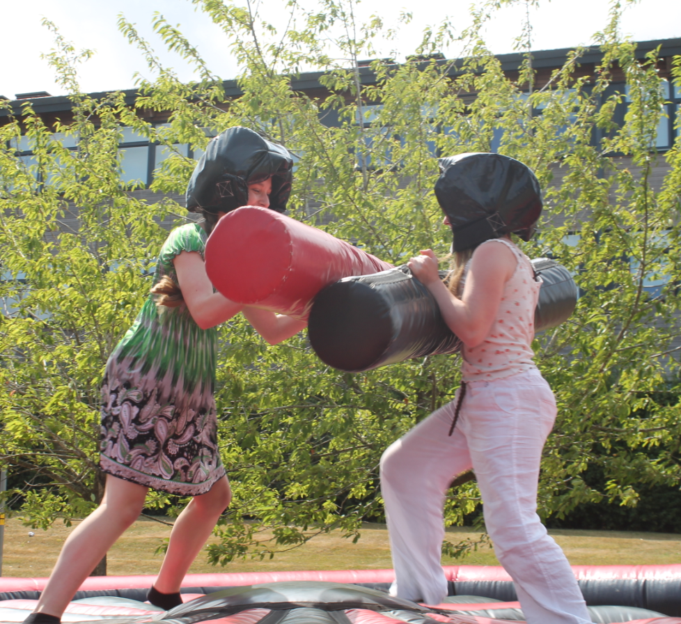 two students enjoying the inflatables