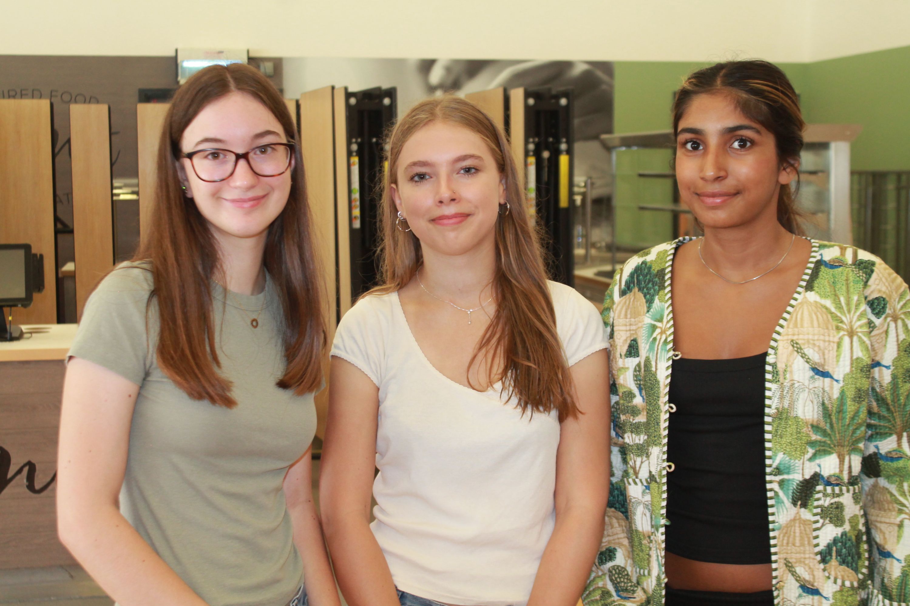 three students celebrating their results