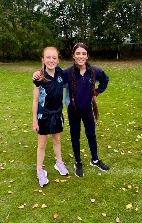 two girls in PE posing for  a photo at the race for life event