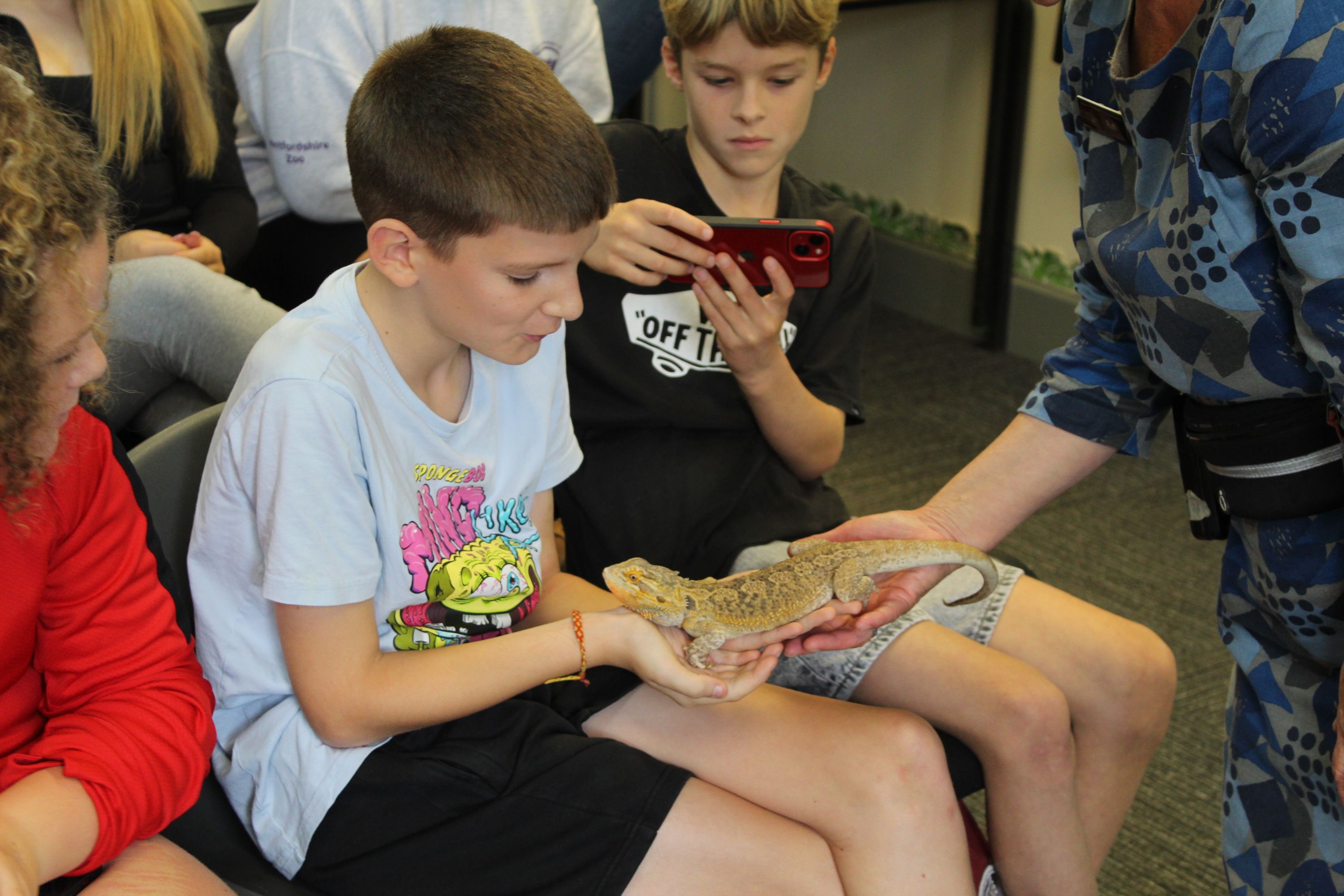 a student holding a lizard
