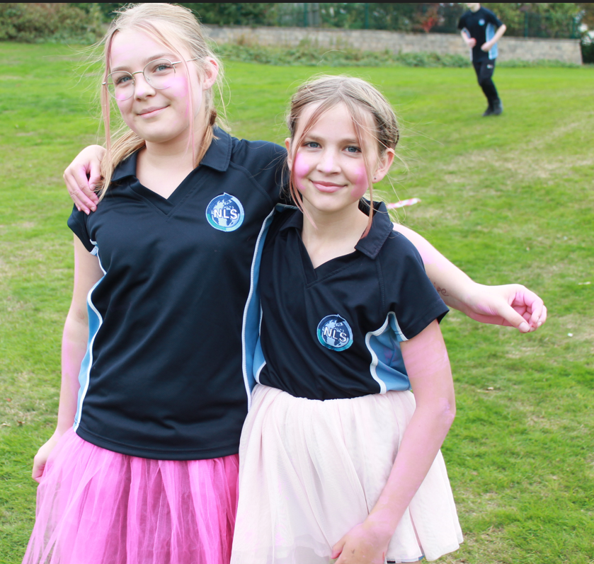 two girls  in PE posing for  a photo at the race for life event
