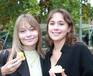 two girls standing together dressed in yellow 