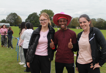 THREE ​​​​PEOPLE STANDING POSING FOR A PHOTOGRPAH