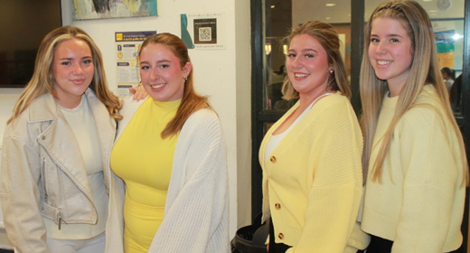 A group of four women standing together