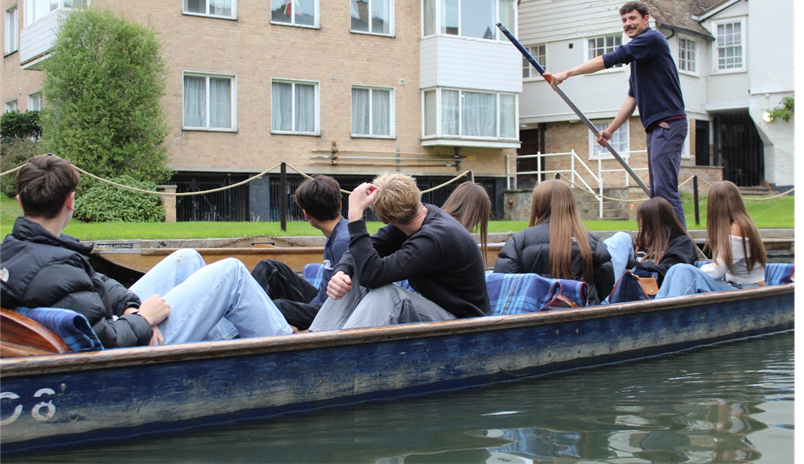 A group of people in a boat punting
