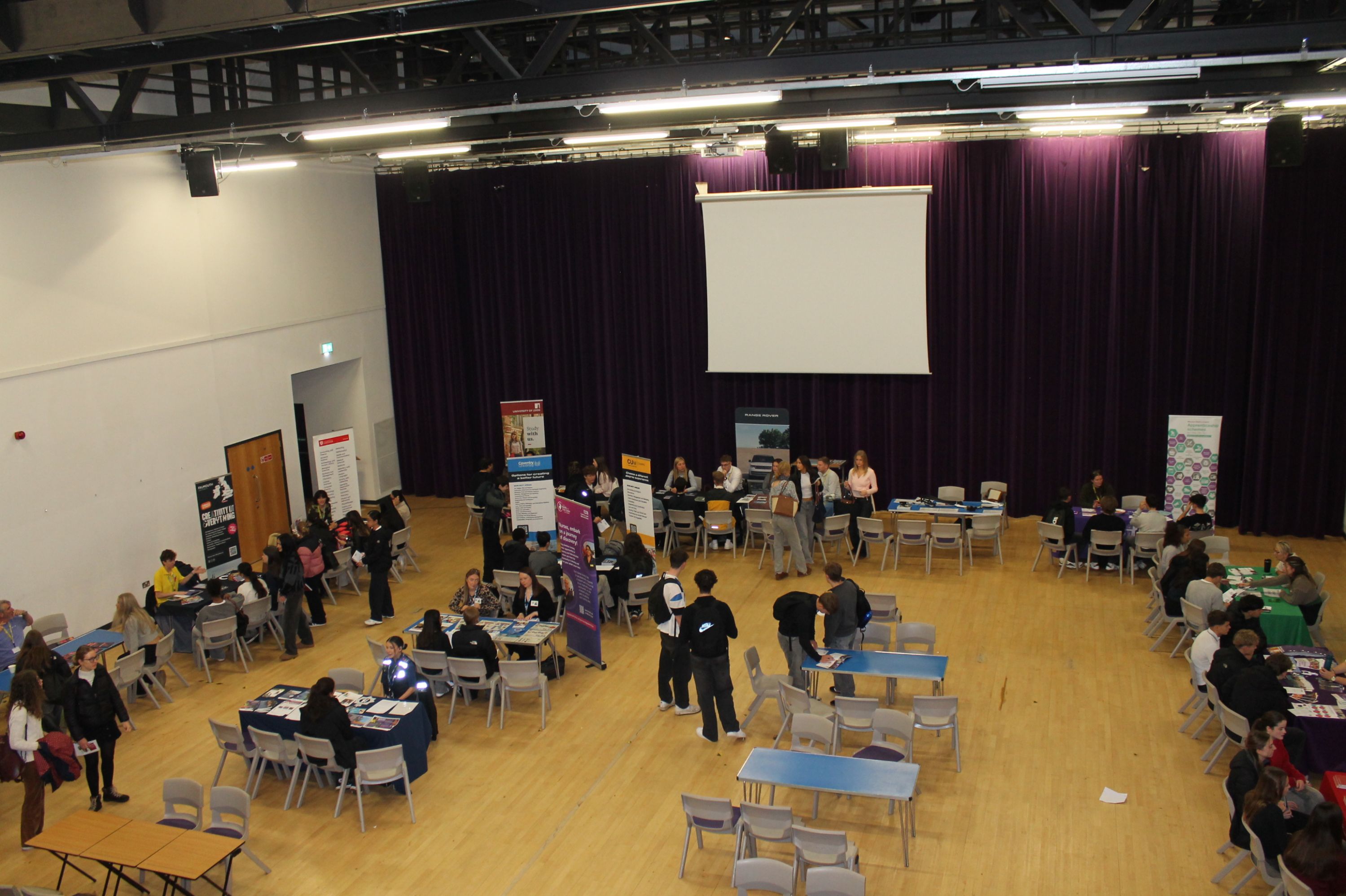 A group of people in the theatre at the careers fair