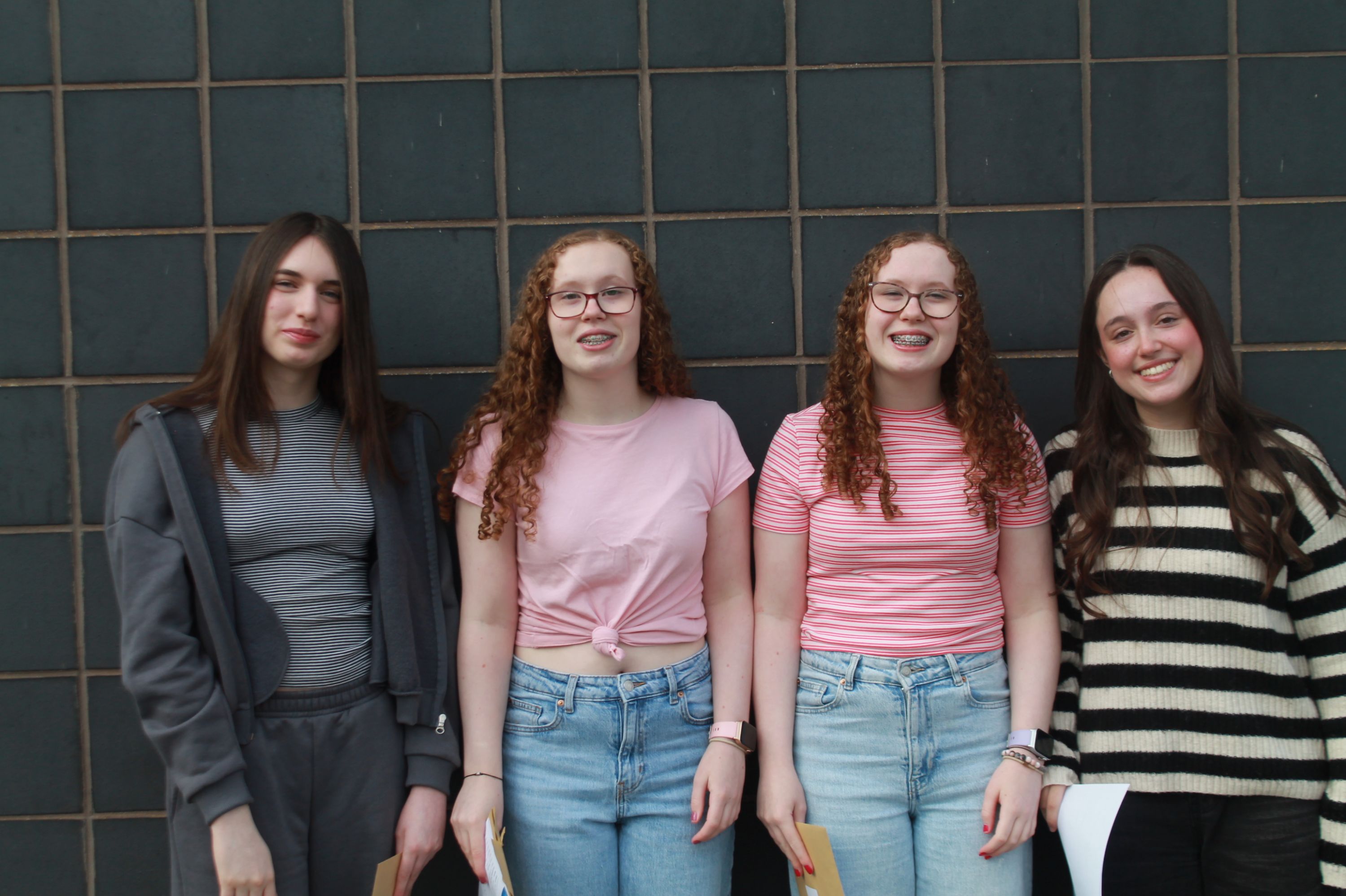 Four students after collecting their exam results  
