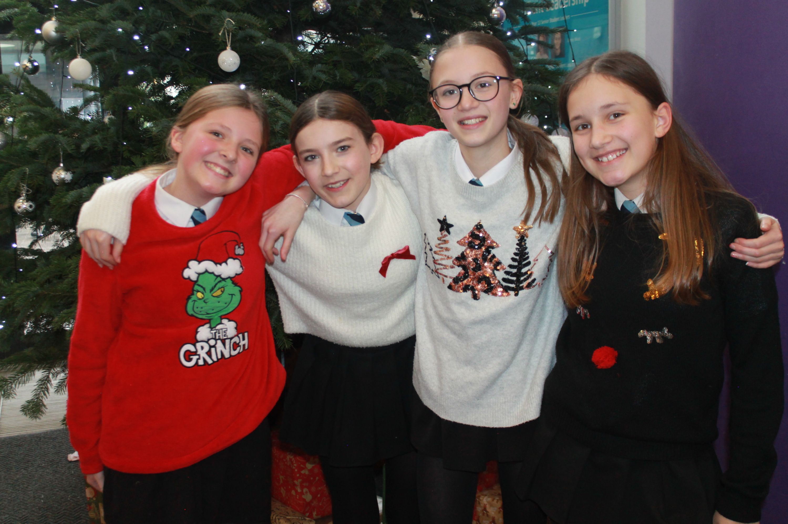 four students posing in their Christmas Jumpers
