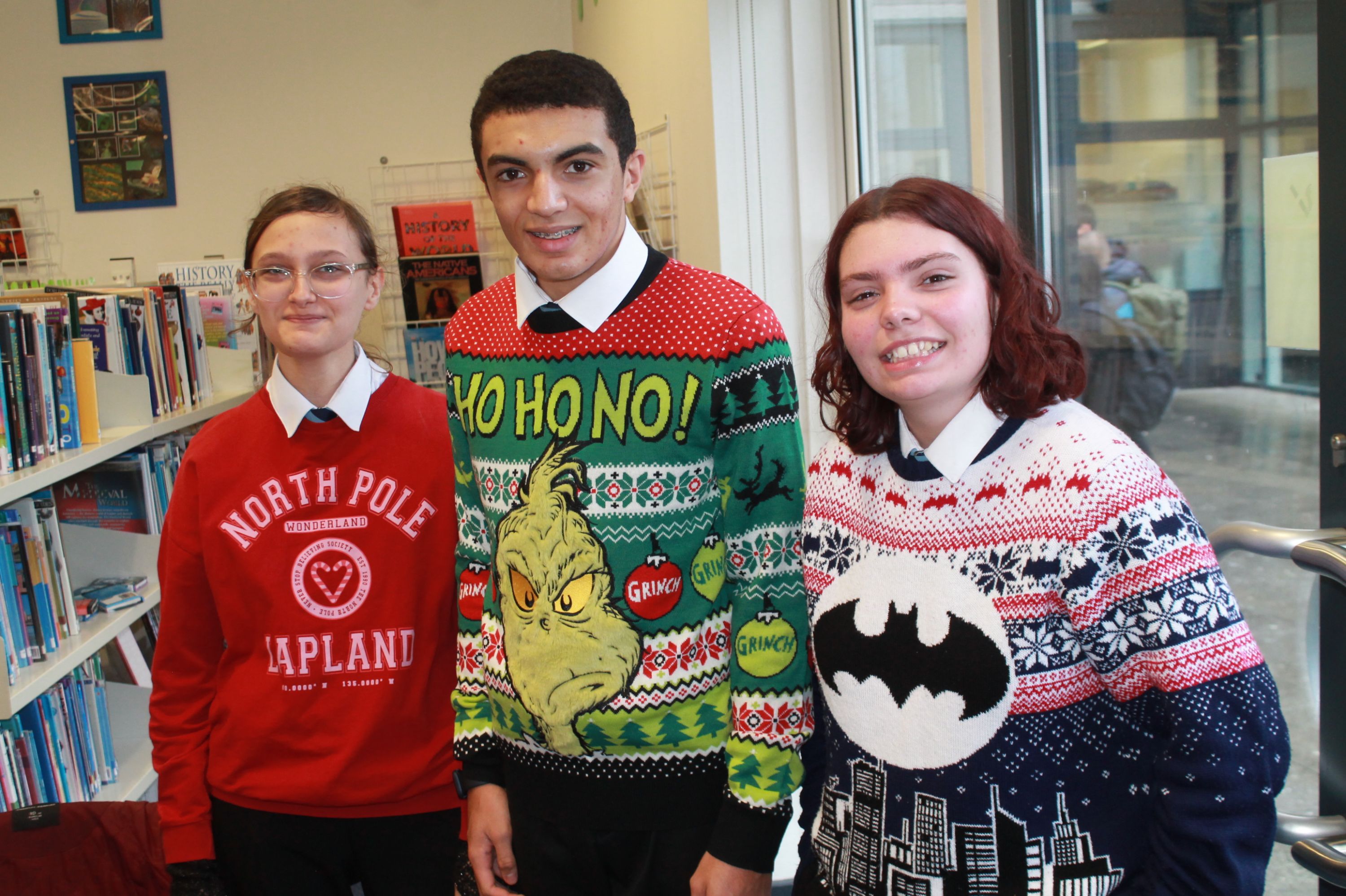 three students posing in their Christmas Jumpers