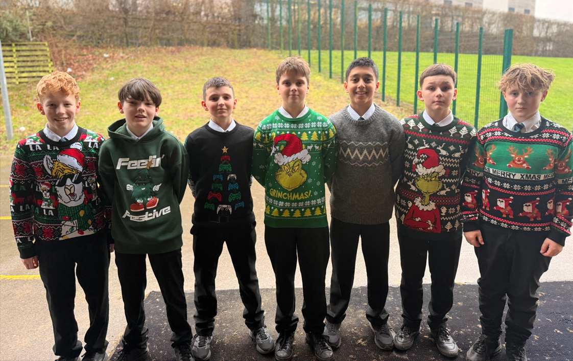 seven students posing in their Christmas Jumpers