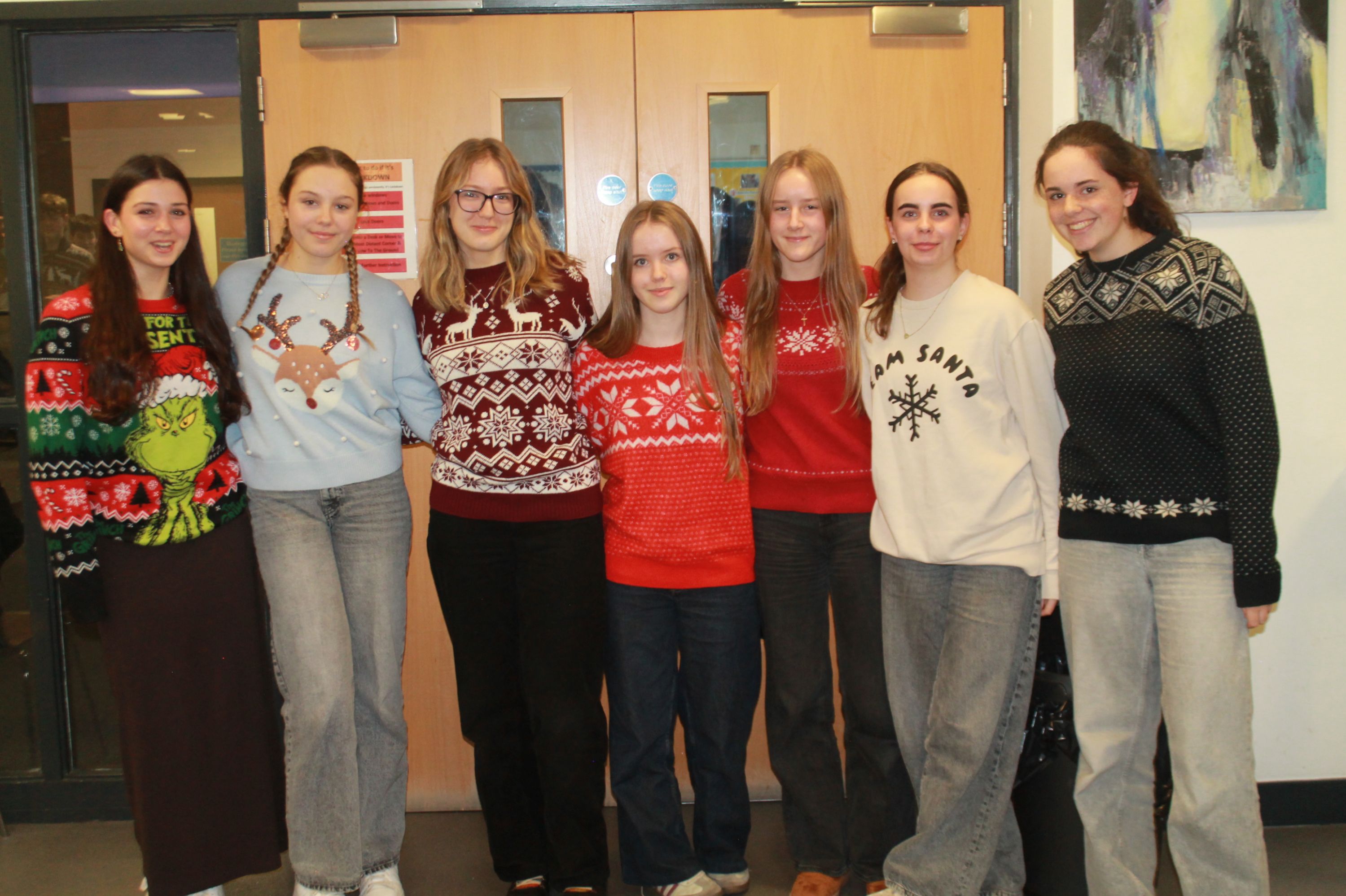 seven students posing in Christmas Jumpers