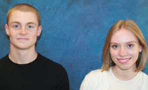 Photograph of two people standing side by side against a blue textured background, one wearing a black top and the other a white top. The image focuses on their upper bodies and faces, with no additional objects or text present.