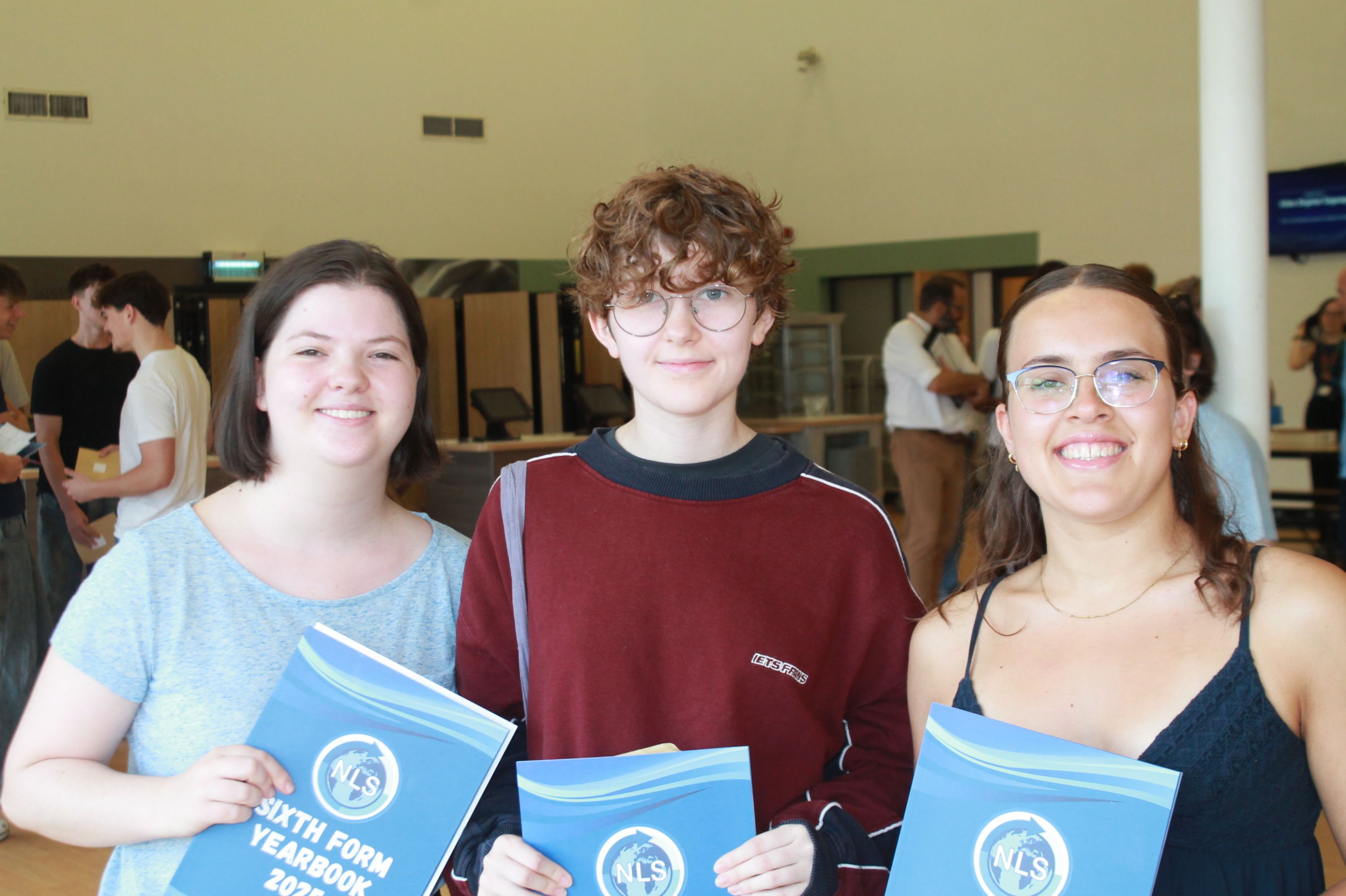 three students celebrating their A Level Results