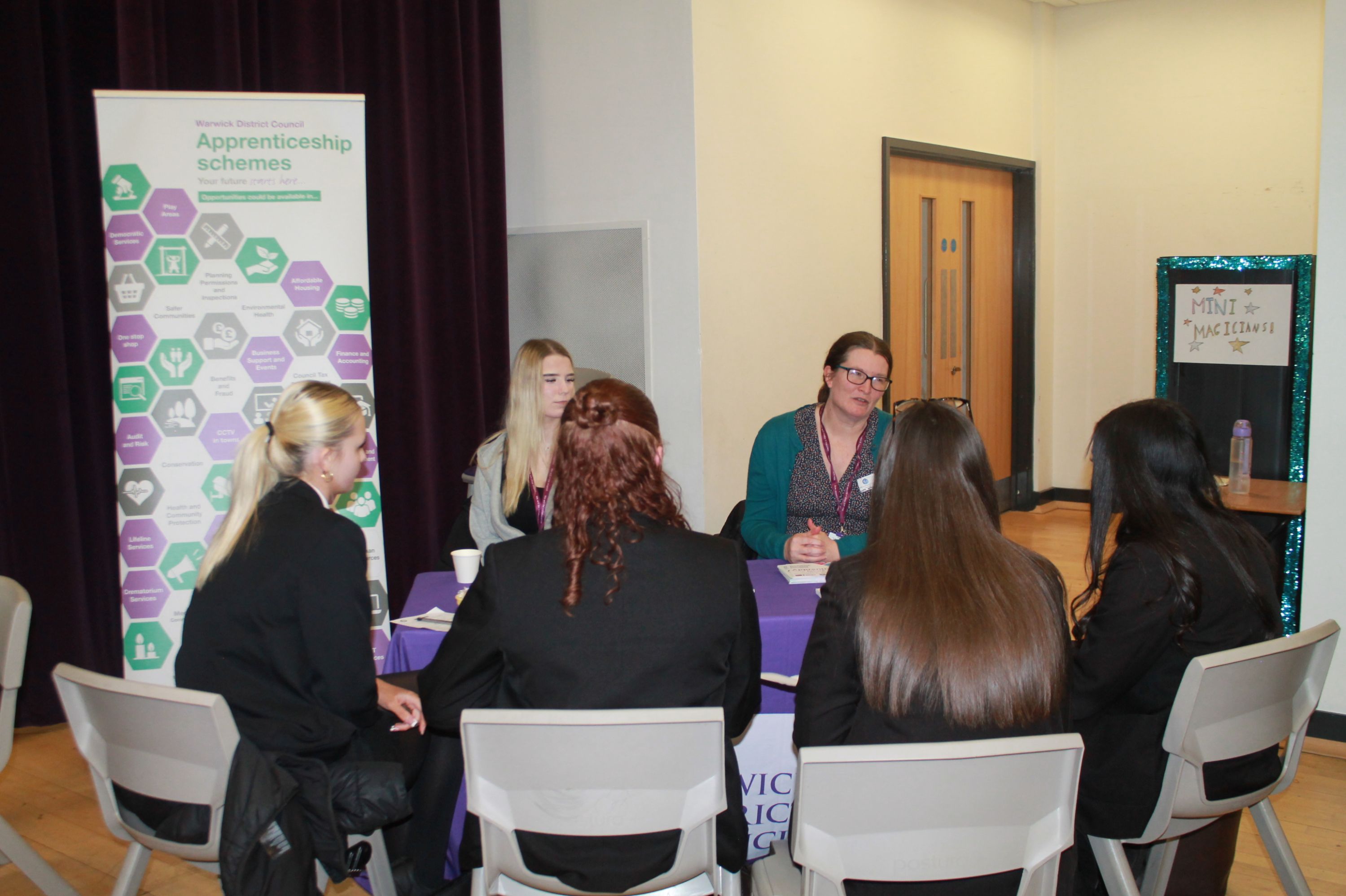 A group of four students  sitting at a table