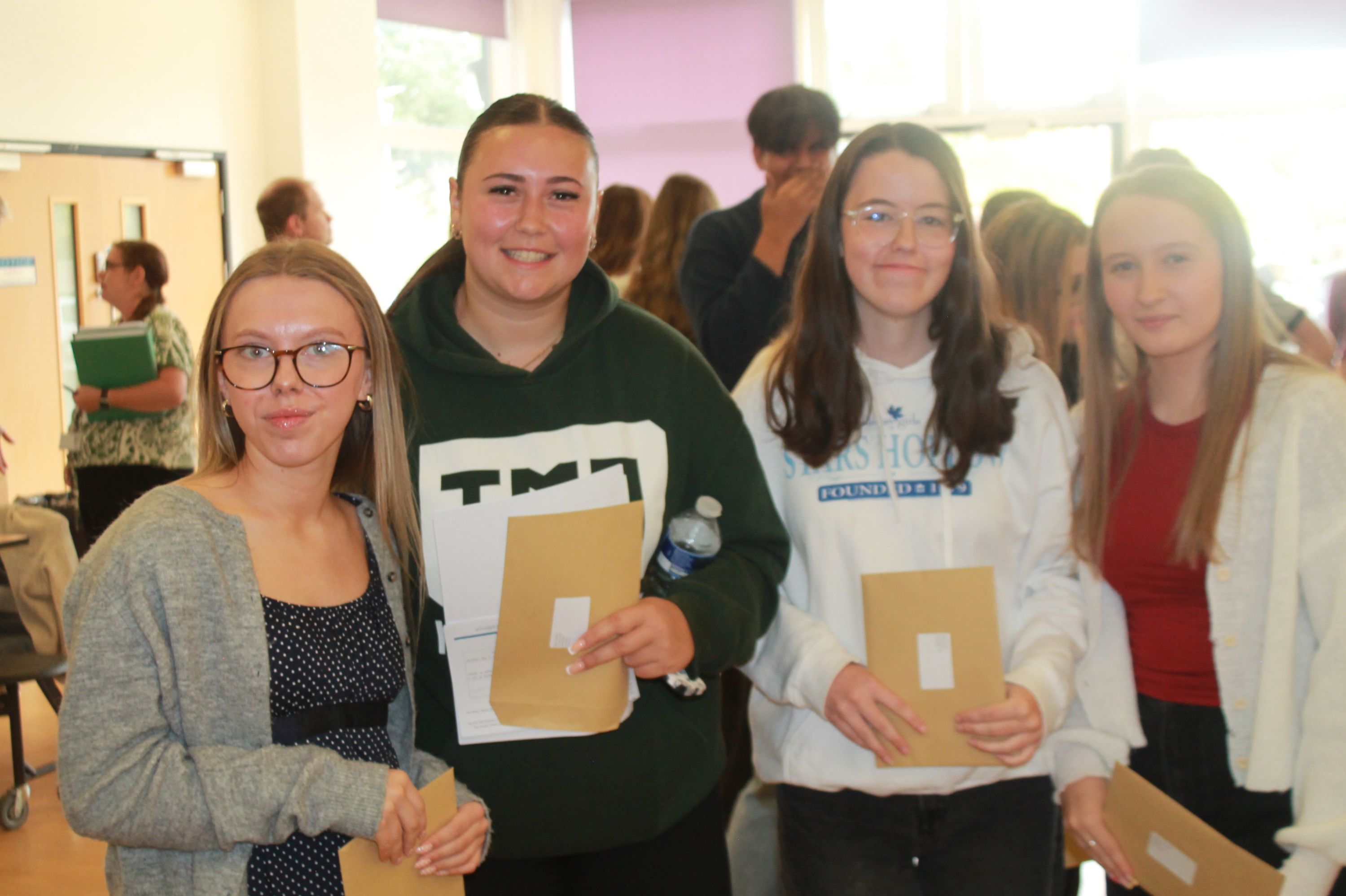 Four students after collecting their exam results  