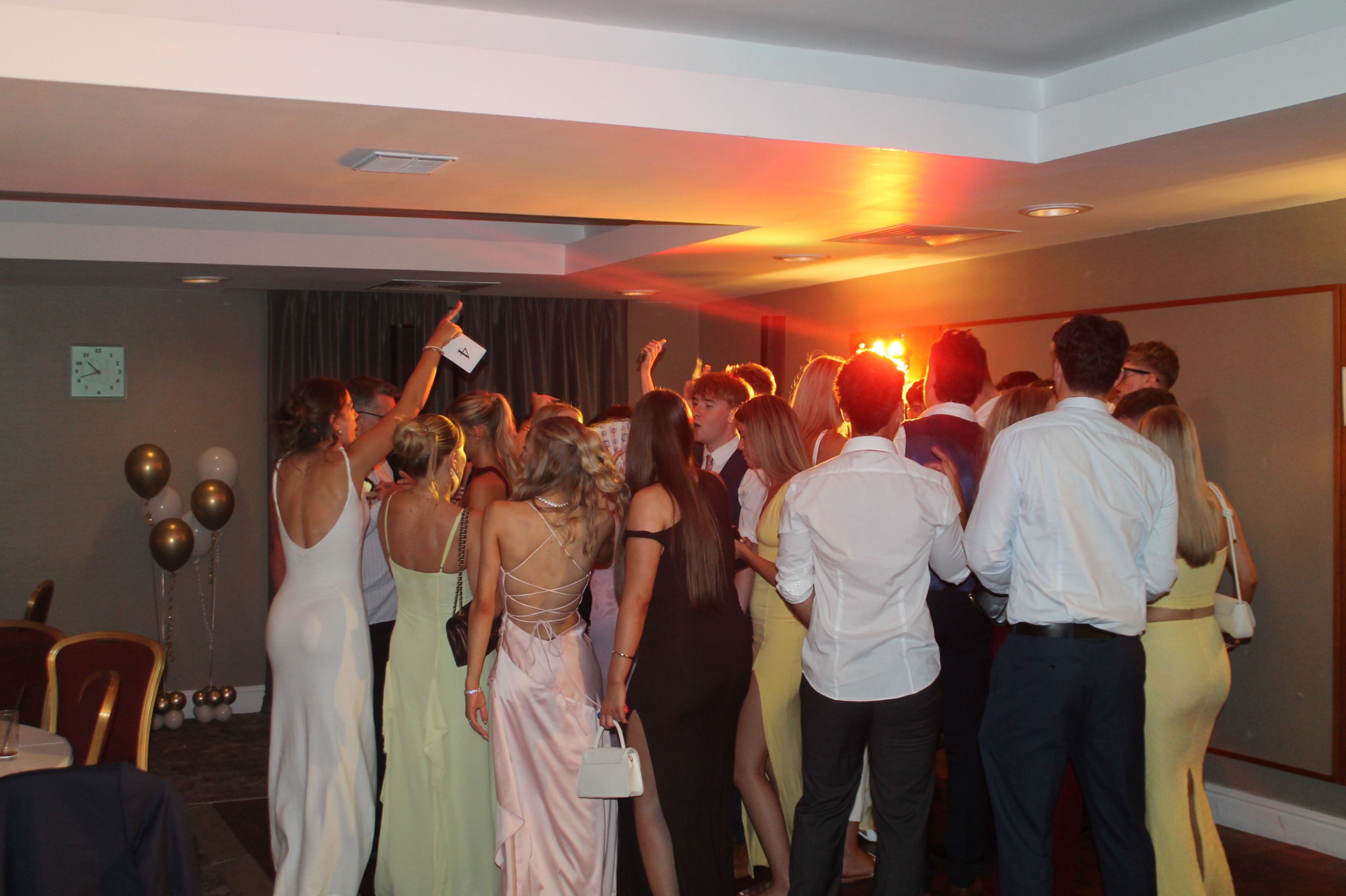 a large group of students dancing at their prom