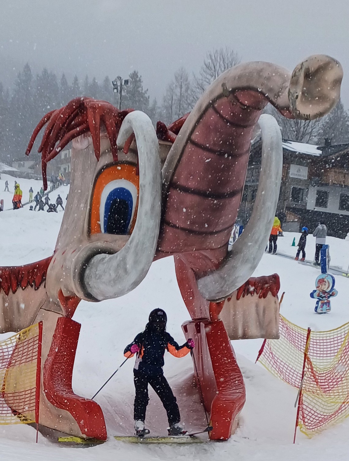 A student skiing through an inflatable on the slope