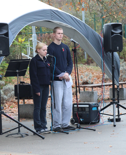 two students standing in front of microphones