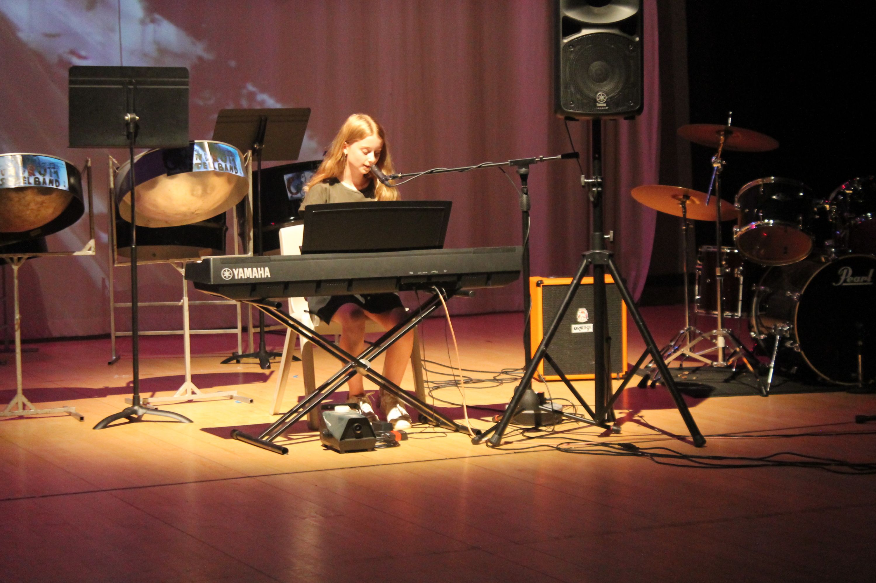 a student singing and playing the keyboard