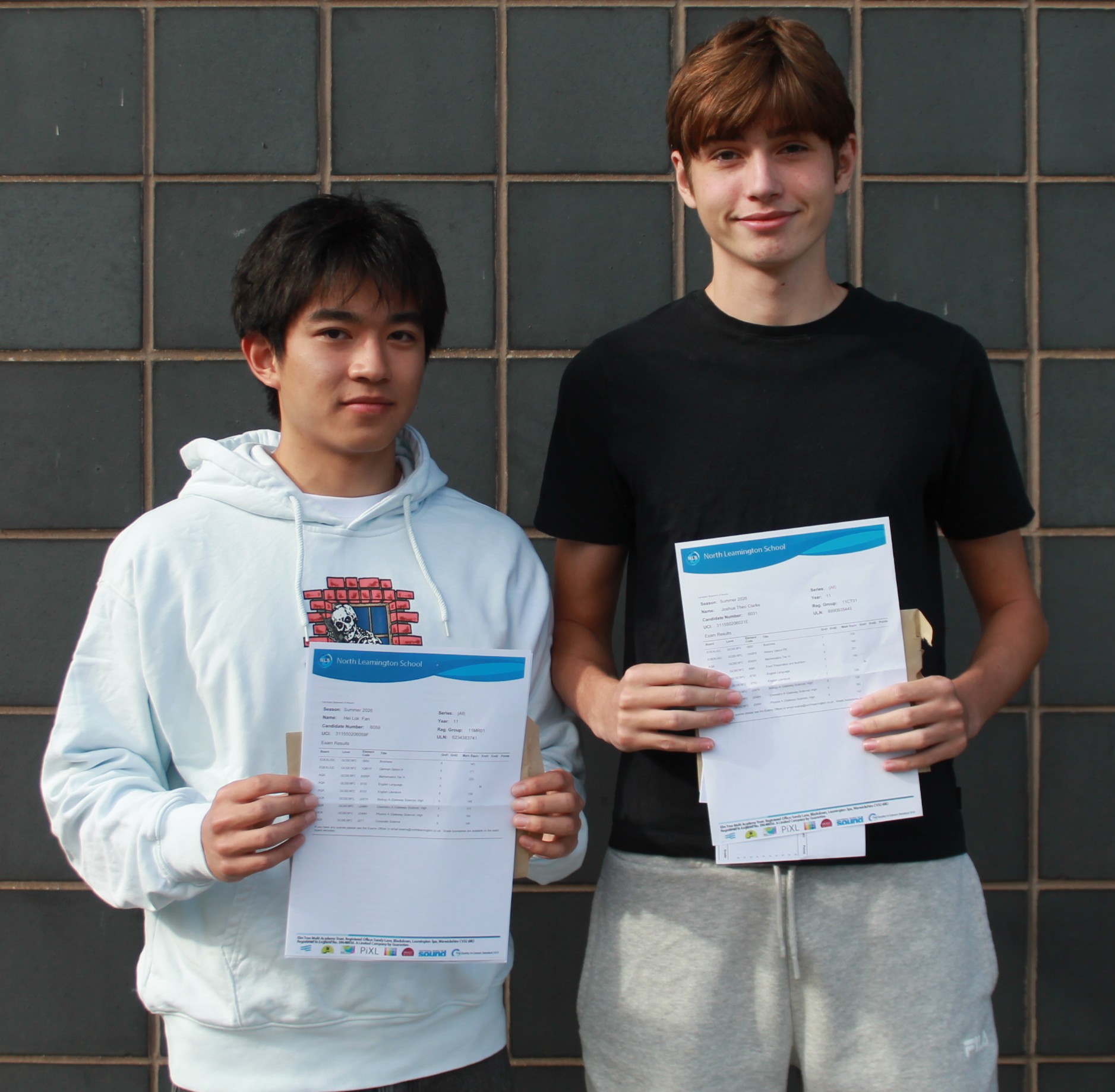 Two students with their GCSE results 