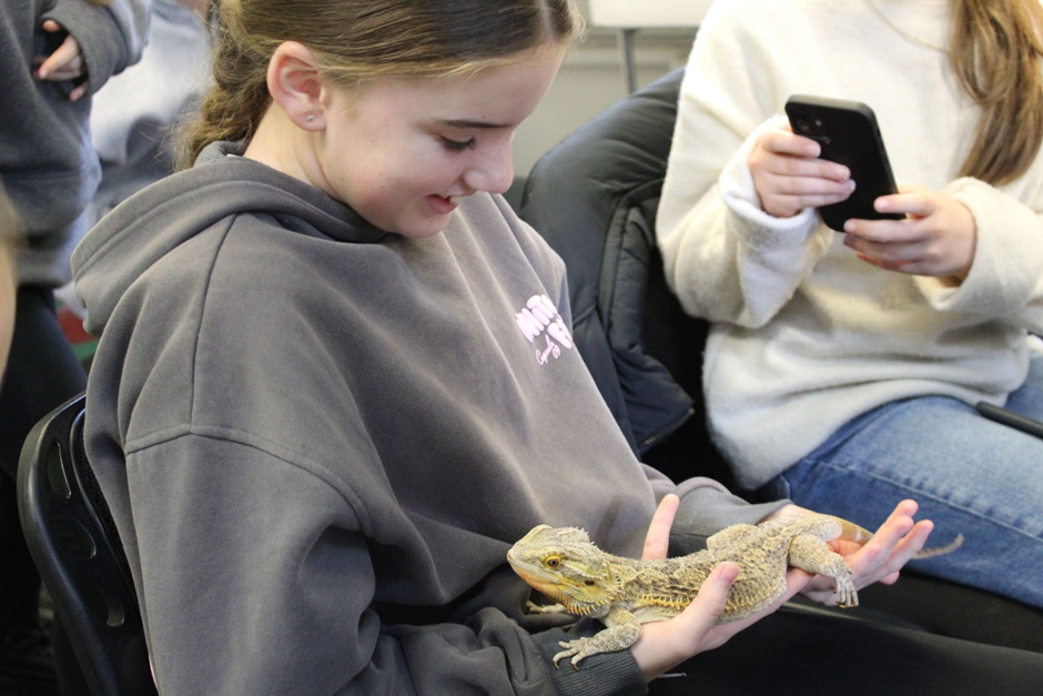 a student holding a lizard