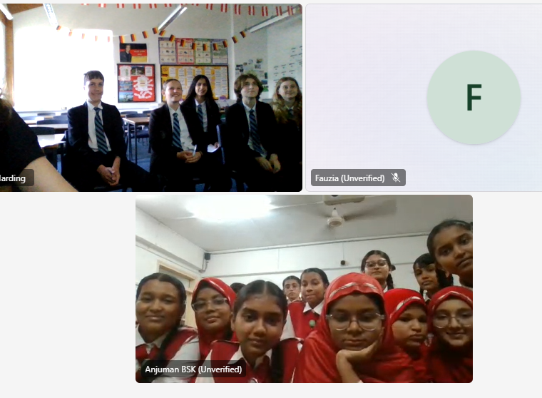 Five NLS students sitting in a classroom on a  call with pupils from our partner school in India