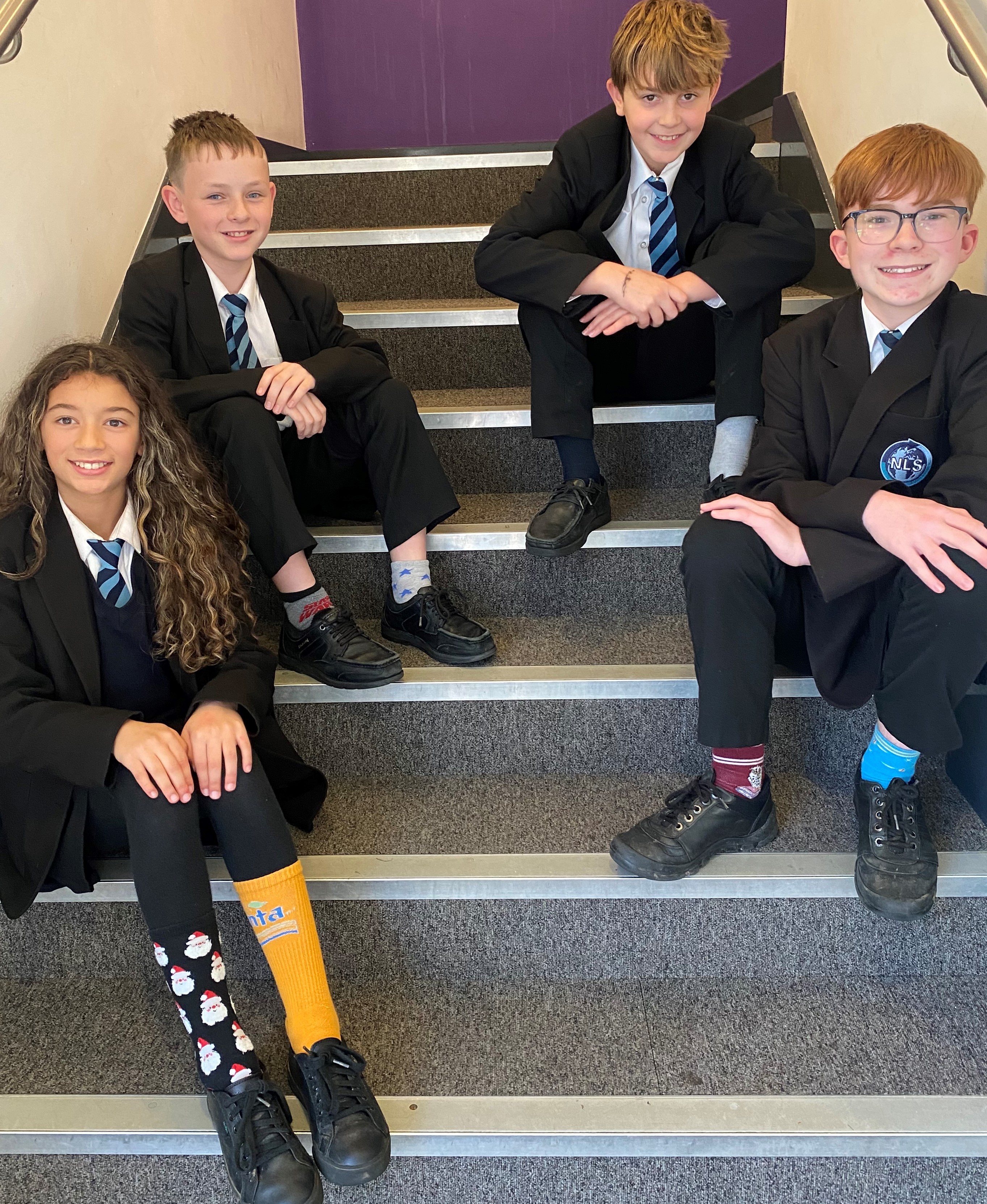 Four students wearing odd socks to  support Anti-Bullying Week