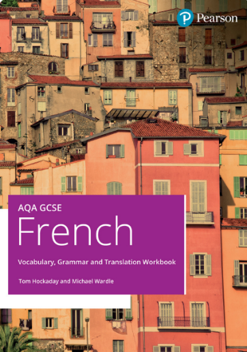 Photograph of a cluster of pastel-coloured Mediterranean-style buildings with various windows and balconies, featuring warm tones of pink, orange, and beige. Overlaid text in a purple box reads "AQA GCSE French Vocabulary, Grammar and Translation Workbook" by Tom Hockaday and Michael Wardle, with a Pearson logo in the top right corner.
