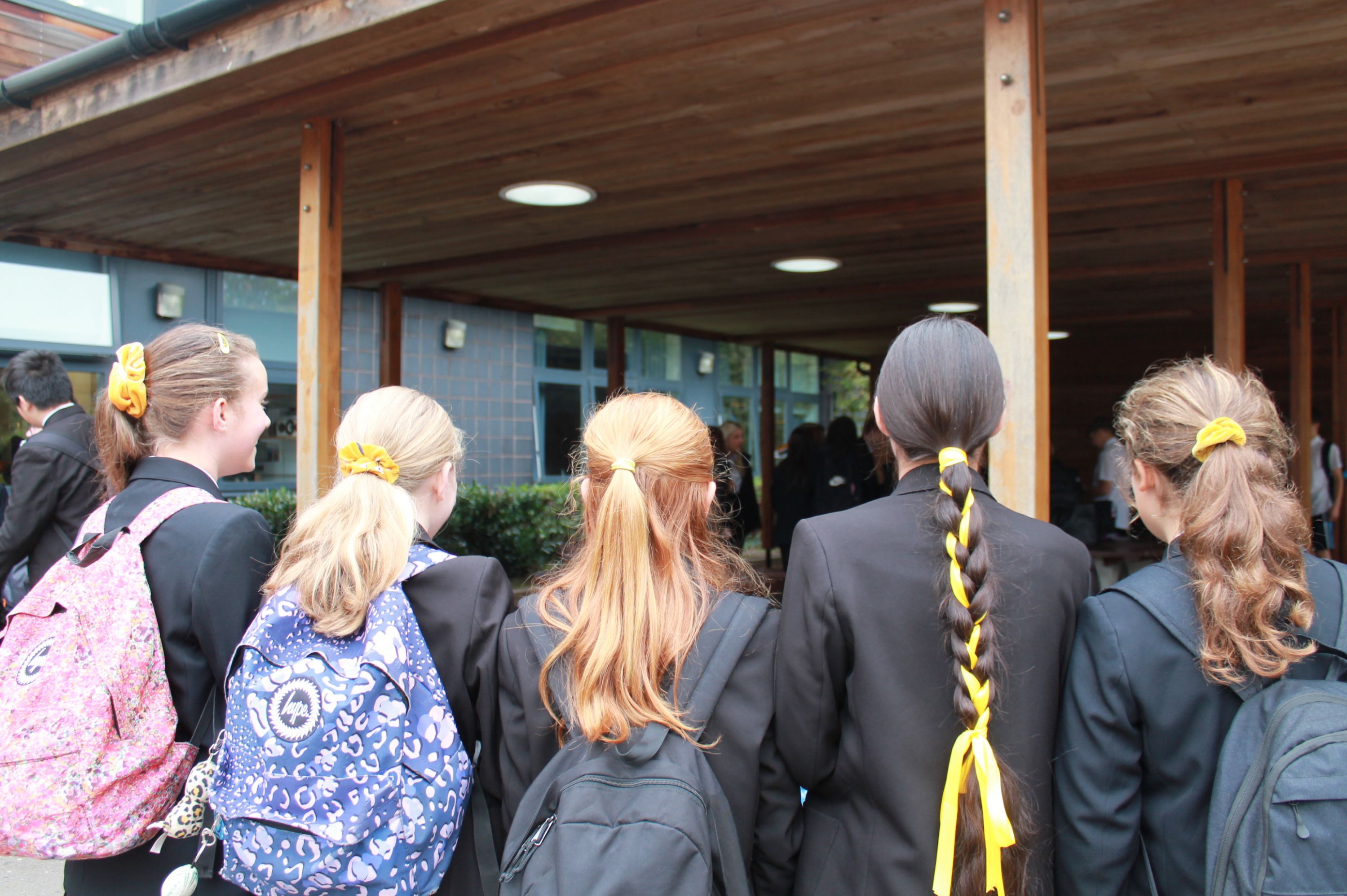 five girls showing their yellow hair ribbons