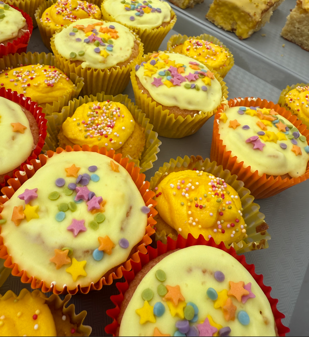tray of yellow iced cakes