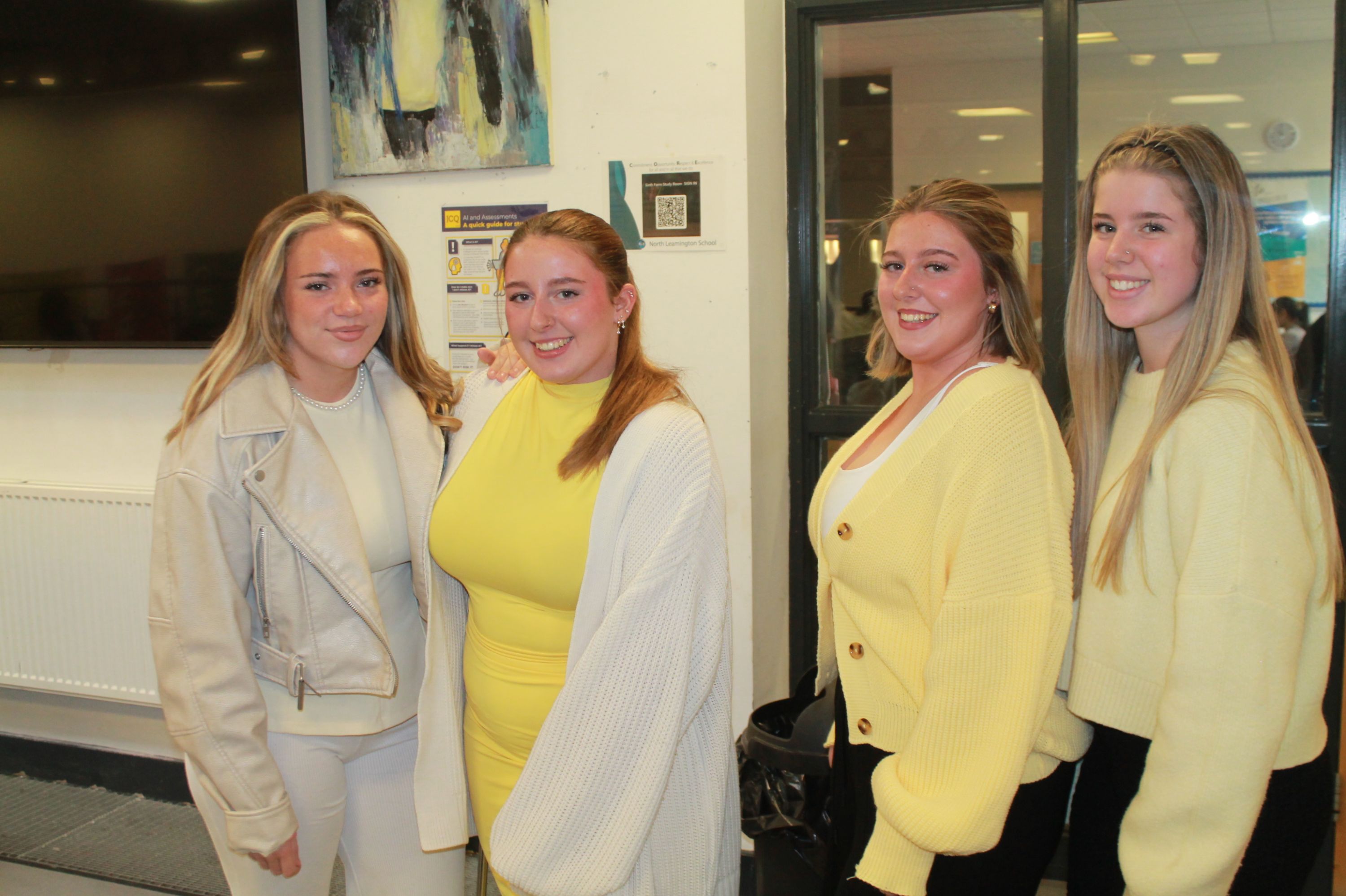 four students wearing yellow tops