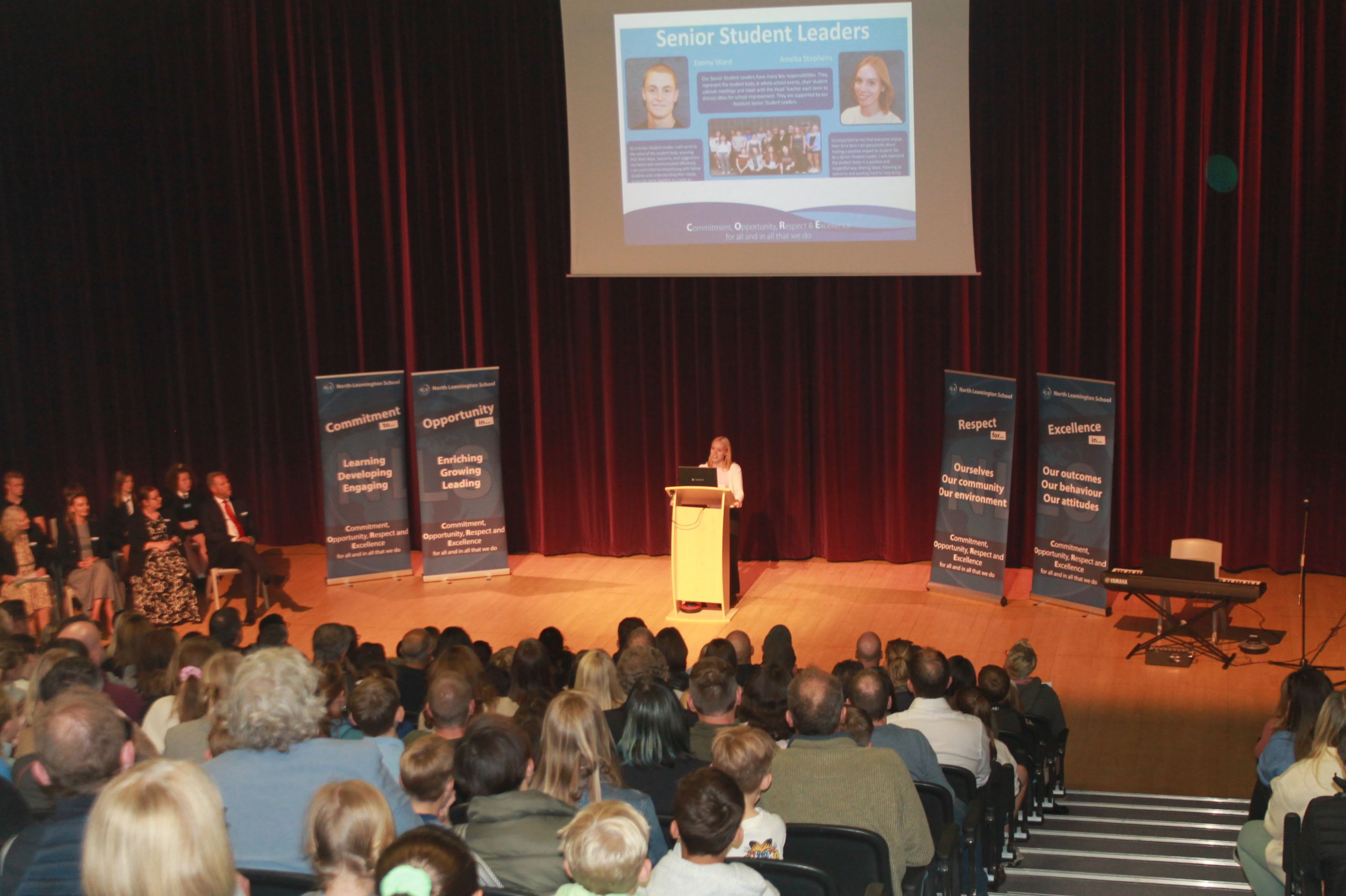 SSL Amelia talking at a lecturn in the theatre about her  experiences 