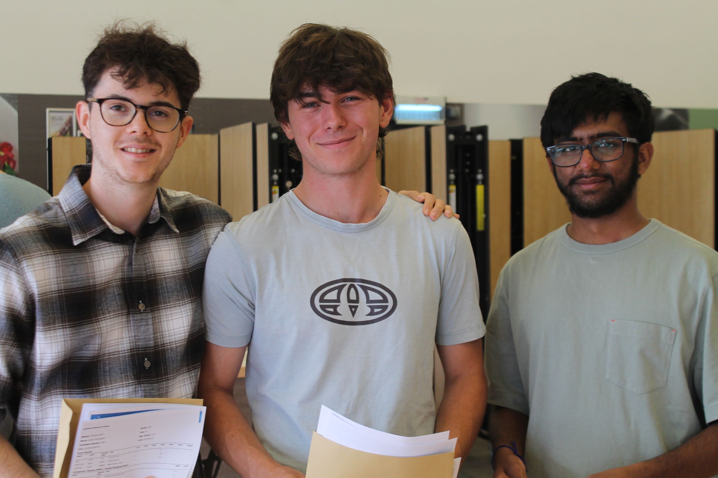 Three students celebrating their A Level Results